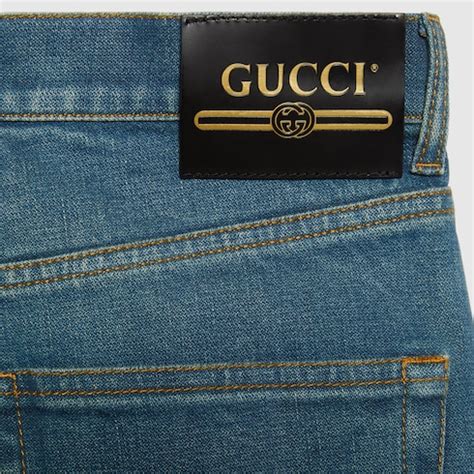 Pantalone in denim con etichetta Gucci in blu 